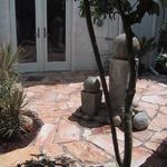 This patio is set on decomposed granite and the mortar lines are infilled with pebble river rock. Thsis is totally appropriate for a lightly used space.