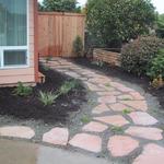 Flagstone pathing moves us to the now private rear outdoor living area.