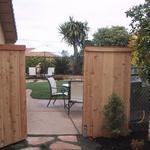 Now complete, we move through a gated entryway to a colored concrete patio outdoor room.