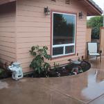 The small planter area under the master bedroom window breaks up the concrete flow and makes it more "hospitable". No function lost here, but beauty added.